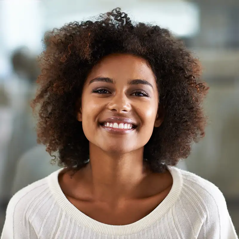Woman with curly hair smiling 